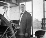 Capt. Bruce Barnes stands at the wheel in the pilothouse