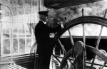 Pilot Lawrence H. Sanders at the wheel of the U. S. Mississippi River Commission Inspection Boat Mississippi, 1907