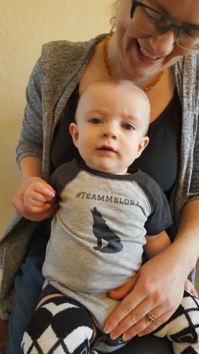 I made custom shirts for my son that were related to the stories my writers' group members had written. Here, he sports his #TeamMelora onesie, which refers to the love triangle in Marie Zhuikov's books, 
