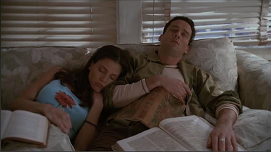 Cordelia and Doyle have fallen asleep researching, so they're leaning on each other on the couch with books still in their laps. Behind them is a window, through which sunlight is visible.