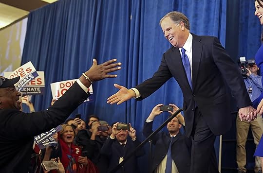Doug Jones is greeted by a supporter before speaking during an election-night watch party in Birmingham, Ala., Dec. 12.