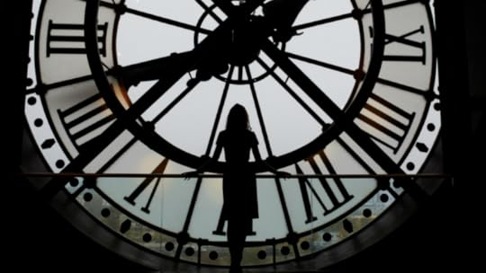 Woman in front of clock tower.png