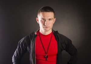 Professional fitness coach isolated on black background