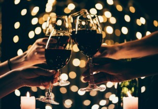 people clinking glasses with wine