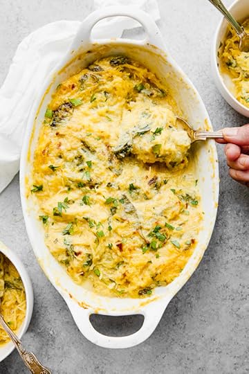 This easy, cheesy baked spaghetti squash is a healthier take on mac and cheese! It's cheesy, loaded with vegetables and feels like comfort food, without the calories and carbs. #spaghettisquash