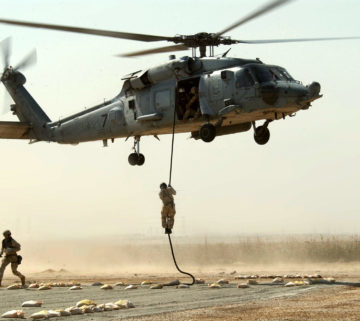 030317-N-5362A-004<br />Central Command Area of Responsibility (Mar. 17, 2003) -- Naval Special Warfare team members conduct a fast rope insertion training exercise from an HH-60H ÒSeahawkÓ helicopter at a forward operating location. U.S. Navy photo by Photographer's Mate 1st Class Arlo K. Abrahamson. (RELEASED)