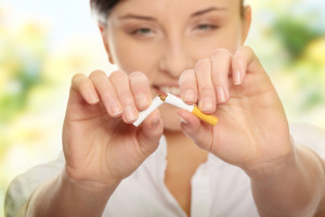 bigstock-Young-woman-breaking-cigarette-13020938
