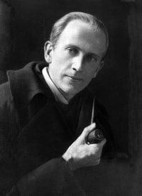 Photo of author A.A. Milne holding a pipe