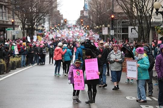 Young Filer and her daughter Hahna, 8 stand along Pine Street during the Seattle Women’s March on Saturday. (Bettina Hansen / The Seattle Times)