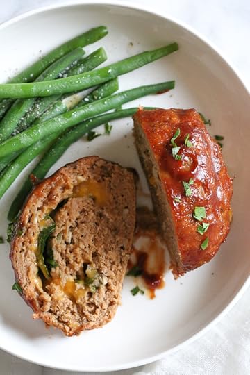 The best tasting, moist turkey meatloaf stuffed with cheddar cheese, spinach and rolled, jelly roll style topped with a ketchup based glaze.