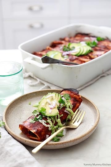Vegetarian enchiladas in a white kitchen. These delicious enchiladas are filled with black beans and corn.