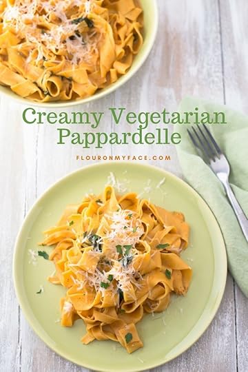 Vegetarian Pappardelle served on a green vintage dinner plate with shredded Parmesan cheese
