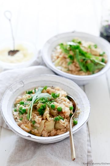 Beautiful rustic bowls of risotto with peas and artichoke hearts.