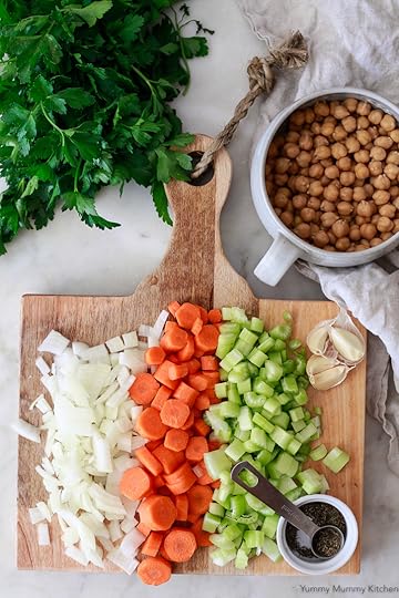 This delicious and easy vegetable soup is prepped by chopping onions, carrots, celery, thyme, and chickpeas.