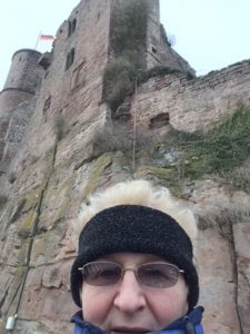 woman in front of castle ruins