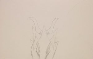 dragon head in pencil peeking over page edge