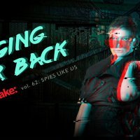 A woman with a VR helmet over her shoulder looks at the camera.