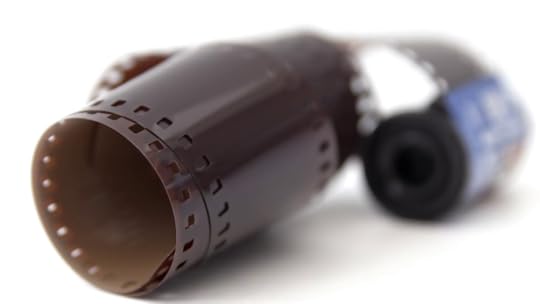 camera-film-negative-concept-hd-stock-footage-stills-camera-film-roll-and-negatives-set-against-a-white-background-and-a-sliding-camera-move-negative-space-for-text-overlays_nj-mcd8nx__F0000