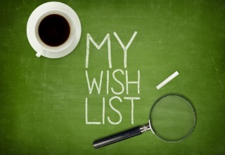 My wish list concept on green blackboard with coffee cup and paper plane