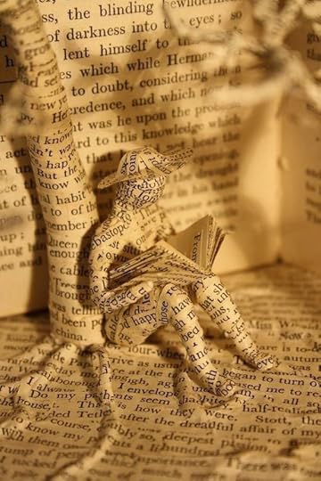 Book sculpture man reading under a tree