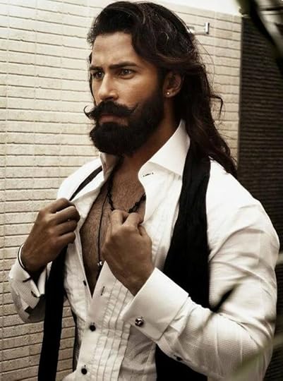 Photo of very sexy muscular man with handlebar mustache, beard and long hair.