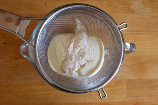 Pressed homemade paneer cheese in the strainer. 