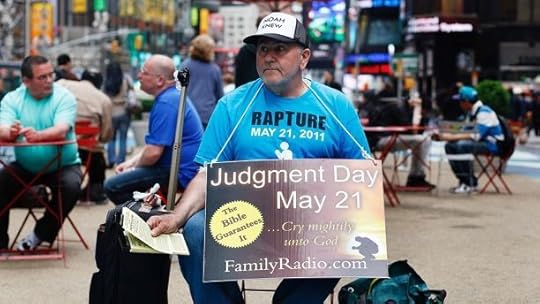 A volunteer from the U.S. religious group Family Radio, a Christian radio network, hands out pamphlets with warnings of an impending Judgment Day at Times Square in New York May 13, 2011. The designation of May 21came from Family Radio president Harold Camping, who predicted that date through a series of mathematical calculations and the unraveling of codes behind the Bible story of the great flood. REUTERS/Shannon Stapleton (UNITED STATES - Tags: RELIGION SOCIETY) - GM1E75E08B501