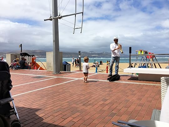 Kid and musician, down by the beach in Las Palmas