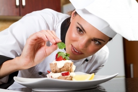 7321566 - beautiful young chef decorating delicious dessert