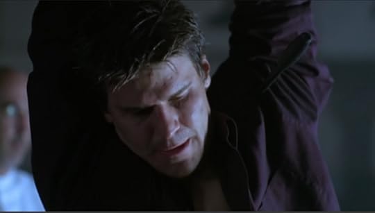 Close-up on Angel with a blurry Marcus visible behind him to the left of the screen