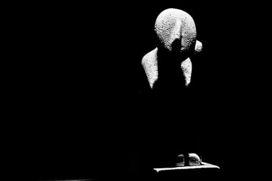 A statue sits bathed in light surrounded by darkness. Shot with a Canon 60D by Jay Sennett