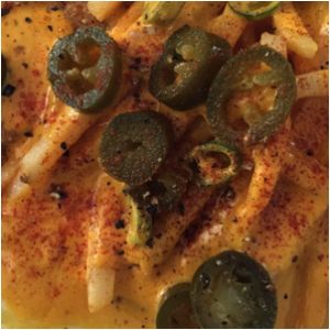 fries with cheese sauce and sliced jalapeños