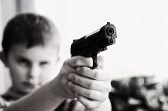 A child holds a pistol