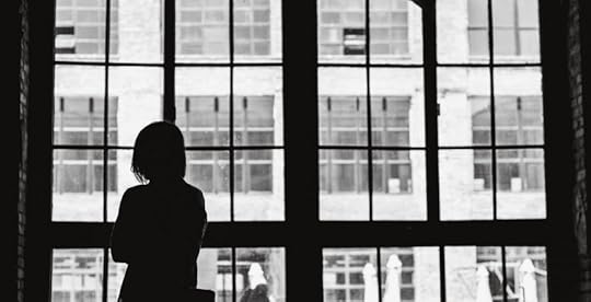 Lonely woman looking out window