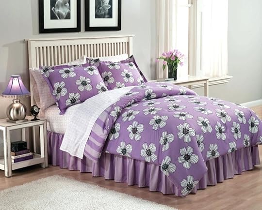 purple and white bedding set with flowers pattern placed on the wooden bed grey baby