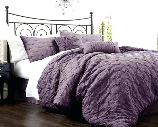 purple and white bedding sets on bed sheets
