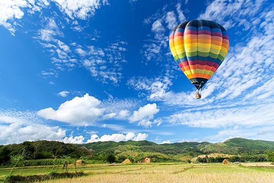 Propose in a Hot air balloon over the field with blue sky