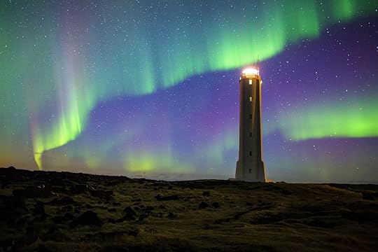Aurora borealis on Iceland with lighthouse, road one