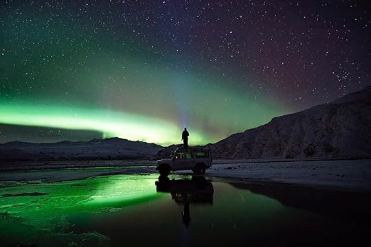 Man on top of car in Iceland