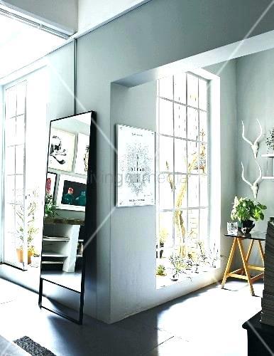 lattice ceiling full length windows floor to and mirror leaning against wall in wood