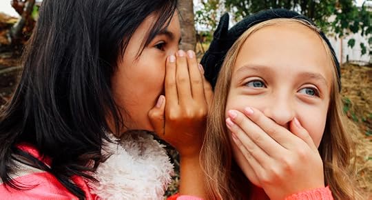 two girls whispering