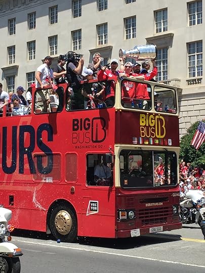 And finally, bringing up the rear, the save-the-best-for-last bus. Seems like we waited forever - you could see the tantalizing gleam of silver when it was still blocks away. Atop the bus: (L to R) Capitals defenseman Brooks Orpik pointing at the crowd, beer in hand; center Nicklas Bäckström; and Captain & winger Alex Ovechkin holding Stanley above his head in iconic fashion. Caps owner Ted Leonsis is visible through the crook of Ovi's arm.