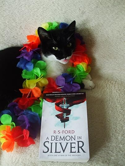 Book, cat, and rainbow bunting.