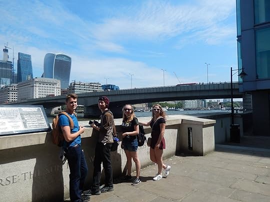 Image may contain: 4 people, people smiling, people standing, sky, bridge and outdoor