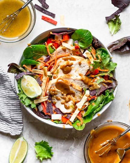 Grilled Chicken Salad with greens and vegetables are tossed in a honey-lime vinaigrette and topped with a delicious peanut sauce.