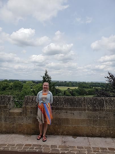 Image may contain: Susan Arnold, smiling, standing, cloud, sky, tree, shoes, child, outdoor and nature