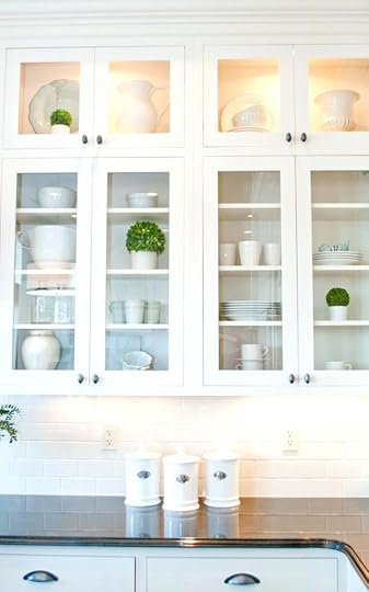 white kitchen cabinets with glass doors front wall