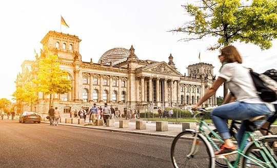 Woman riding bike by Reichstag in Berlin