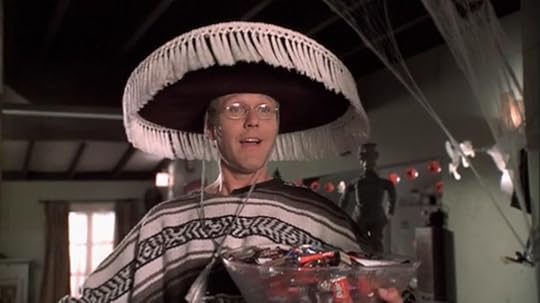 Giles is wearing a sarape and sombrero, holding a bowl of candy. He is uncharacteristically psyched for Halloween.