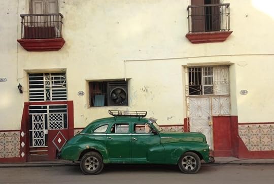 Old car against wall in Cuba